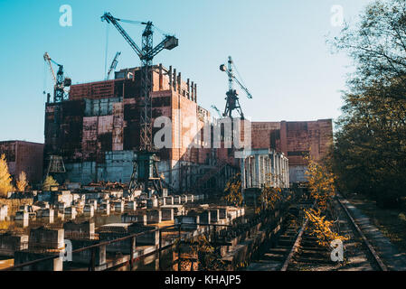 An incomplete building construction lies in ruins near the Chernobyl power plant, Ukraine Stock Photo