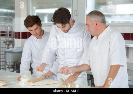 smiling cooks making french chausson Stock Photo