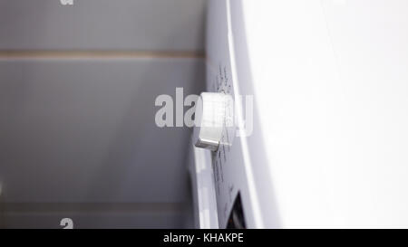 Close Up Of Man Choosing Cycle Program On Washing Machine Stock Photo