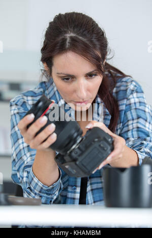 Photographer checking shots on camera screen Stock Photo - Alamy