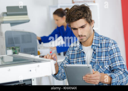 young technician working on a printer Stock Photo