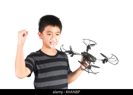 Asian boy holding hexacopter drone and radio remote control (controlling handset) for helicopter, drone or plane, studio shot isolated on white backgr Stock Photo