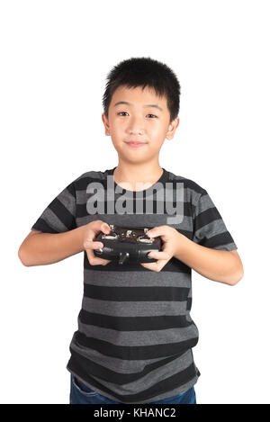Asian boy holding radio remote control (controlling handset) for helicopter, drone or plane, studio shot isolated on white background. Stock Photo