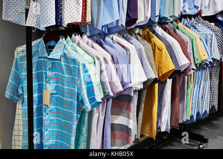 Men's shirts with short sleeves in the clothing store Stock Photo