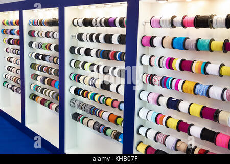 Multicolored ribbons and braid in a sewing shop Stock Photo