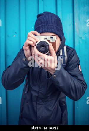 Young man with instant camera Stock Photo