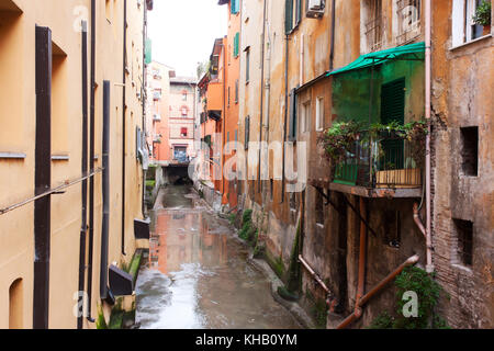 Old water canal hidden behind a window in Bologna  , Italy Stock Photo