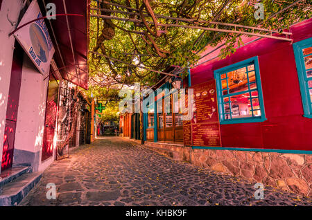 Molyvos,Lesvos - the picteresque stone alley with the traditional shops which it was voted as the nicest alley of the world. Stock Photo