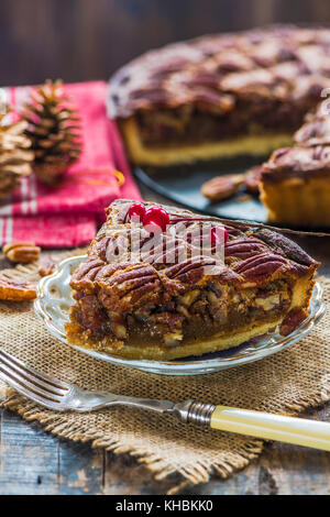 Pecan pie on rustic wooden table. Christmas baking. Stock Photo
