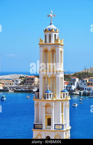 The bell tower of the church of Agios Nikolaos above Emborio harbour on the Greek island of Halki. Stock Photo