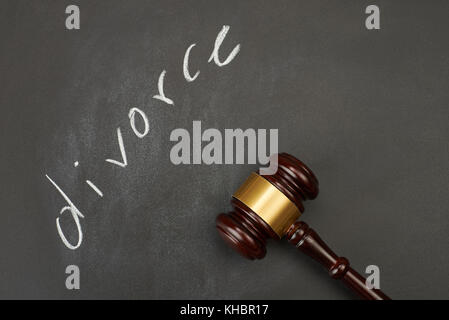 Judge gavel on blackboard background writing the word 'divorce'. Stock Photo