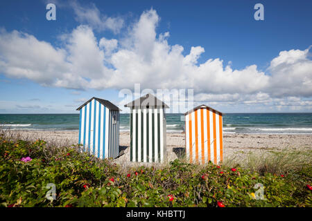 Colourful beach huts on pebble beach with blue sea and sky with clouds, Rageleje Strand, Kattegat Coast, Zealand, Denmark, Europe Stock Photo