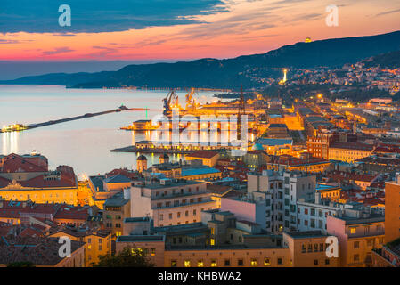 Aerial view of the illuminated waterfront and harbor at night ...