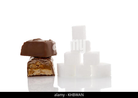 Chocolate bar and sugar cubes isolated on white background. Unhealthy eating. Sugar and carbs. Stock Photo