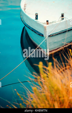 Lonely fishing boat in sea lagoon water Stock Photo