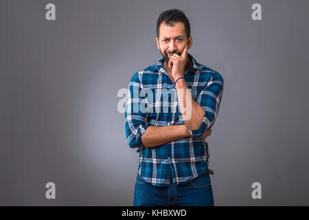 A young black man standing and thinking Stock Photo