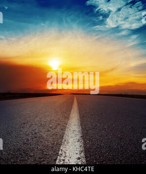 good sunset over asphalt road Stock Photo - Alamy