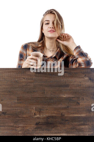 Young pretty blonde woman in brown  plaid shirt with coffee mug . Beautiful girl isolated on white background. Stock Photo