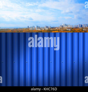 Fence made of metal panels a blue color outdoors Stock Photo
