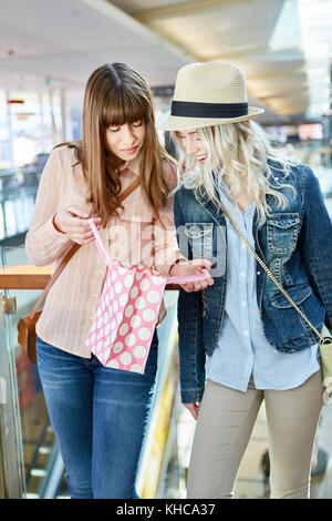 Two teenage girls with shopping bags shopping at mall Stock Photo