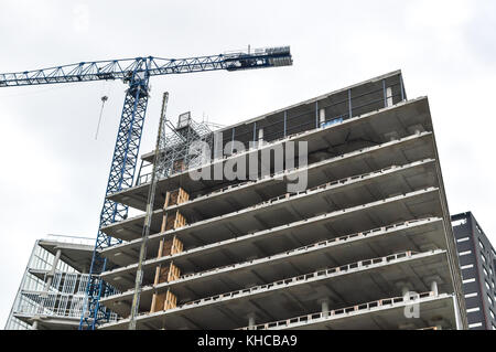 Building crane and building under construction against blue sky in Canada Stock Photo