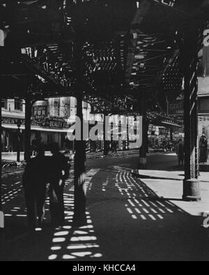 Black and white picture showing long shadows cast on streets on the Lower East Side of Manhattan, photo by Bernice Abbott, New York, 1936. From the New York Public Library. Stock Photo