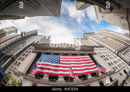 A giant American flag is unfurled across the facade of the New York Stock Exchange on 11:11 AM to commemorate Veterans Day (observed) in New York on Friday, November 10, 2017. Originally knows as Armistice Day, the holiday memorializes that on the eleventh hour of the eleventh day of the eleventh month the guns fell silent in1918 marking the end of World War I.  The holiday has since been expanded to include all American soldiers from all wars.(© Richard B. Levine) Stock Photo