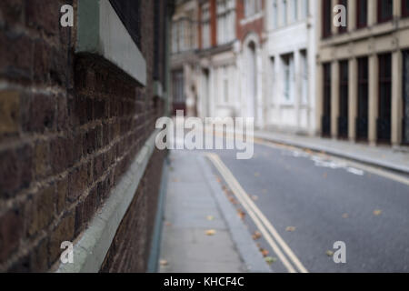 Looking onto an empty back street in London. Camera is pushed against the wall for a subjective view. Stock Photo