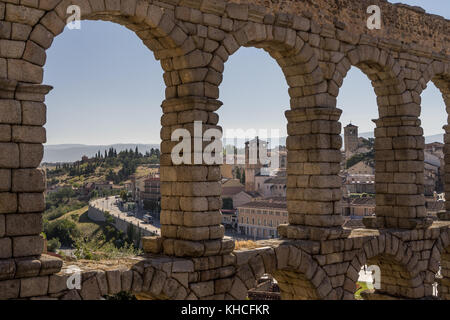 view of the village through the ancient roman aqueduct bridge in Segovia Spain. Stock Photo