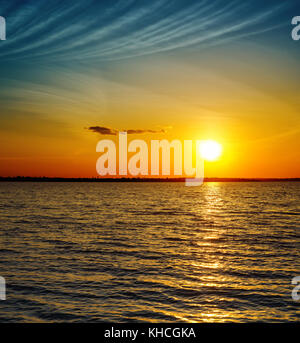 golden sunset over dark water Stock Photo
