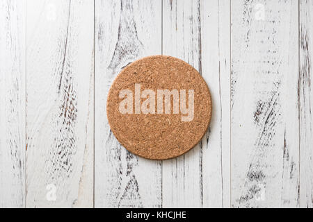 Cork Coaster on white wooden table background Stock Photo