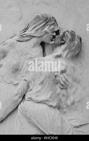 A gravestone on San Michele, Venice's cemetery island, depicting a couple embracing Stock Photo