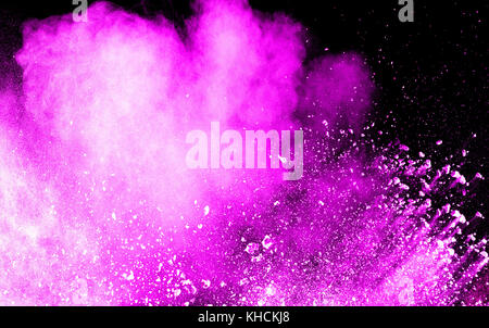 abstract pink dust explosion on  black background.abstract pink powder splattered on dark  background. Freeze motion of pink powder splash. Stock Photo