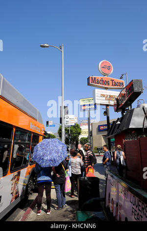 Passengers boarding a bus at a bus stop on Vermont Avenue in Los Feliz, Los Angeles, California USA  KATHY DEWITT Stock Photo