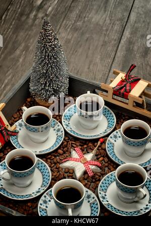 Cups with coffee,pattern design concept-cups of coffee on wooden tray and christmas decorations. Stock Photo