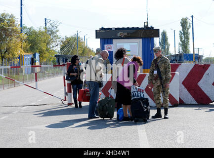 Border guard checking bags of travelers at the border crossing point Kalanchak, Ukrainian-Russian border. Sept 20,2017. Khersonskaya oblast, Ukraine Stock Photo