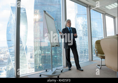 Mature business man making a presentation Stock Photo