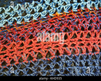 Knitted background with different colors on tree bark Stock Photo