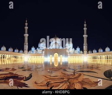 Grand Mosque in Abu Dhabi at night. Panorama of exterior of Sheikh Zayed Mosque with backlite. Beautiful arabic mosque. Stock Photo