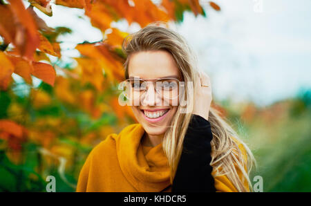 Woman smile in autumn leaves, happy Stock Photo