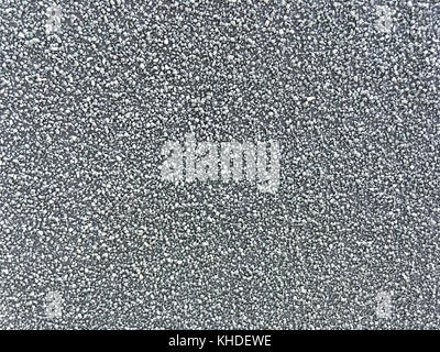 Background of scattered gray fine gravel. Texture of a stone surface, closeup. Stock Photo