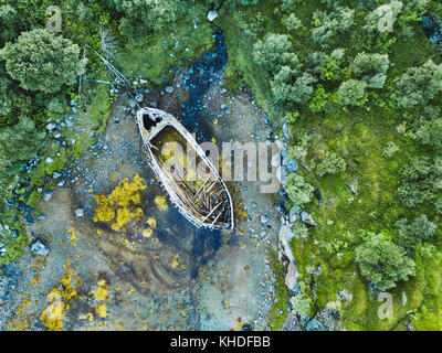 beautiful aerial shot of abandoned wooden boat on the beach Stock Photo