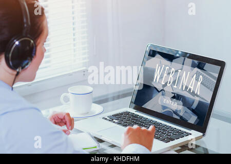woman watching webinar online on computer, business education concept, coaching Stock Photo