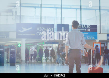 business travel, man passenger in airport waiting for the flight in modern terminal Stock Photo