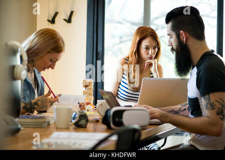 Group working together in shared office space Stock Photo