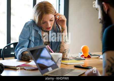 College students studying at shared table Stock Photo
