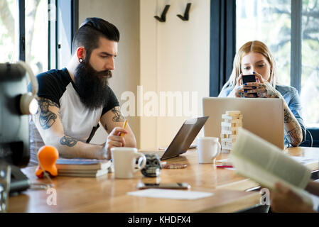 Working in shared casual office Stock Photo
