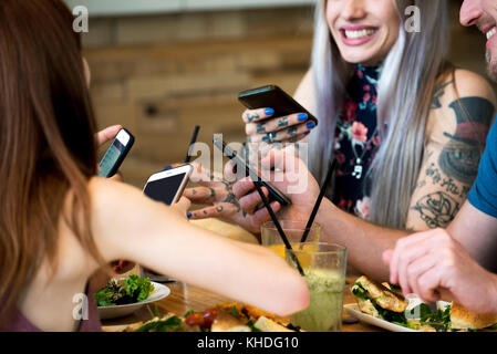 Friends all using smart phones Stock Photo