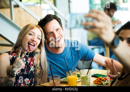 Couple posing for selfie in restaurant Stock Photo