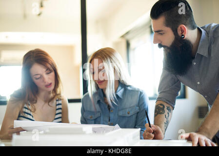 Colleagues discussing project in casual office Stock Photo